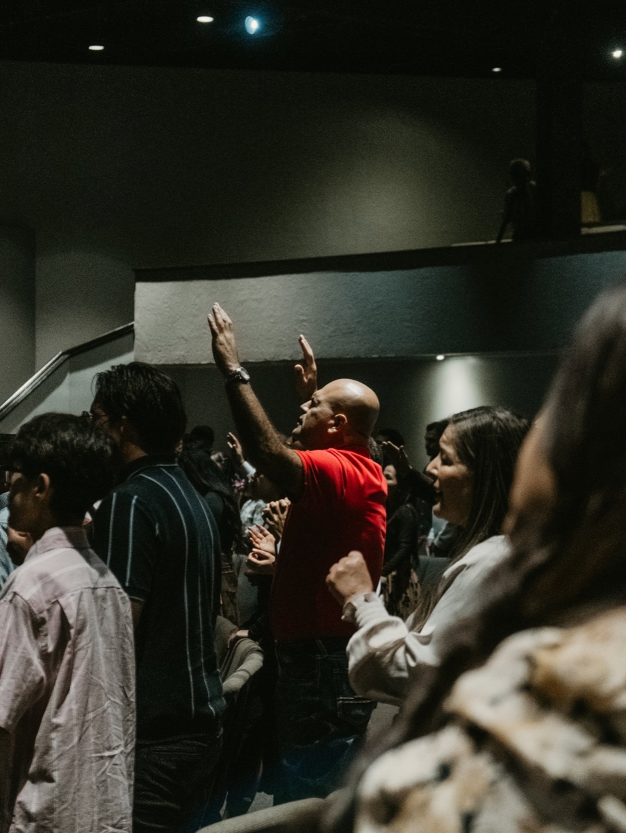 Congregation worshipping with hands raised