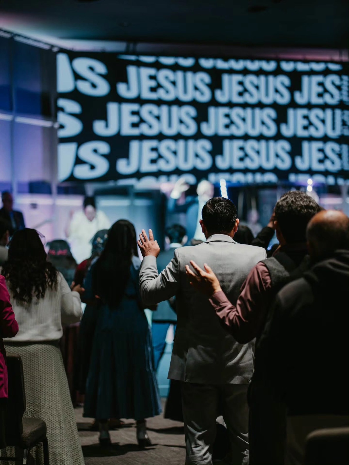 Congregation worshipping inside The Vine Apostolic Church