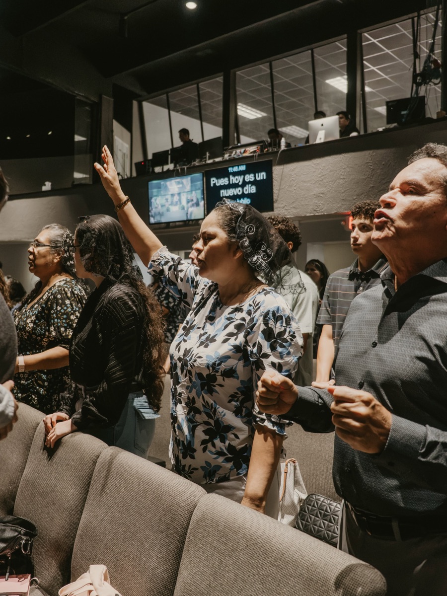 Woman worshipping with hands raised